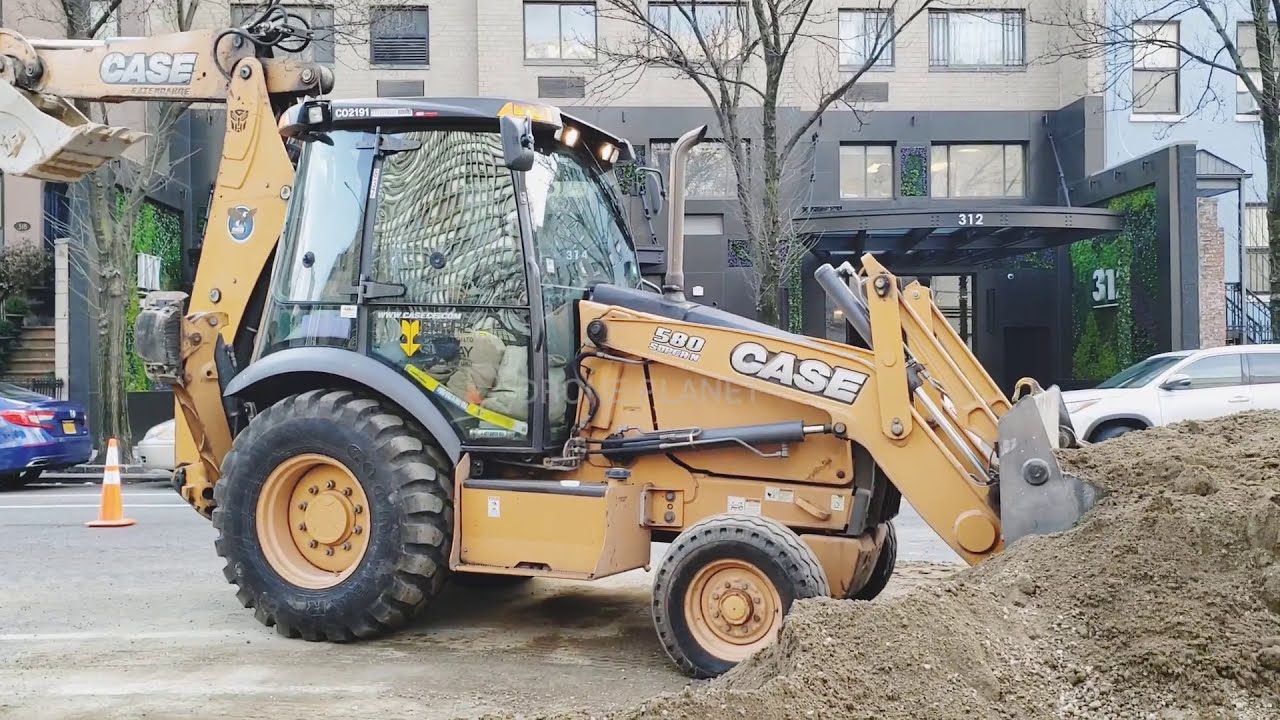 JCB CASE BACKHOE WORKING ON THE ROAD AT NEW YORK CITY
