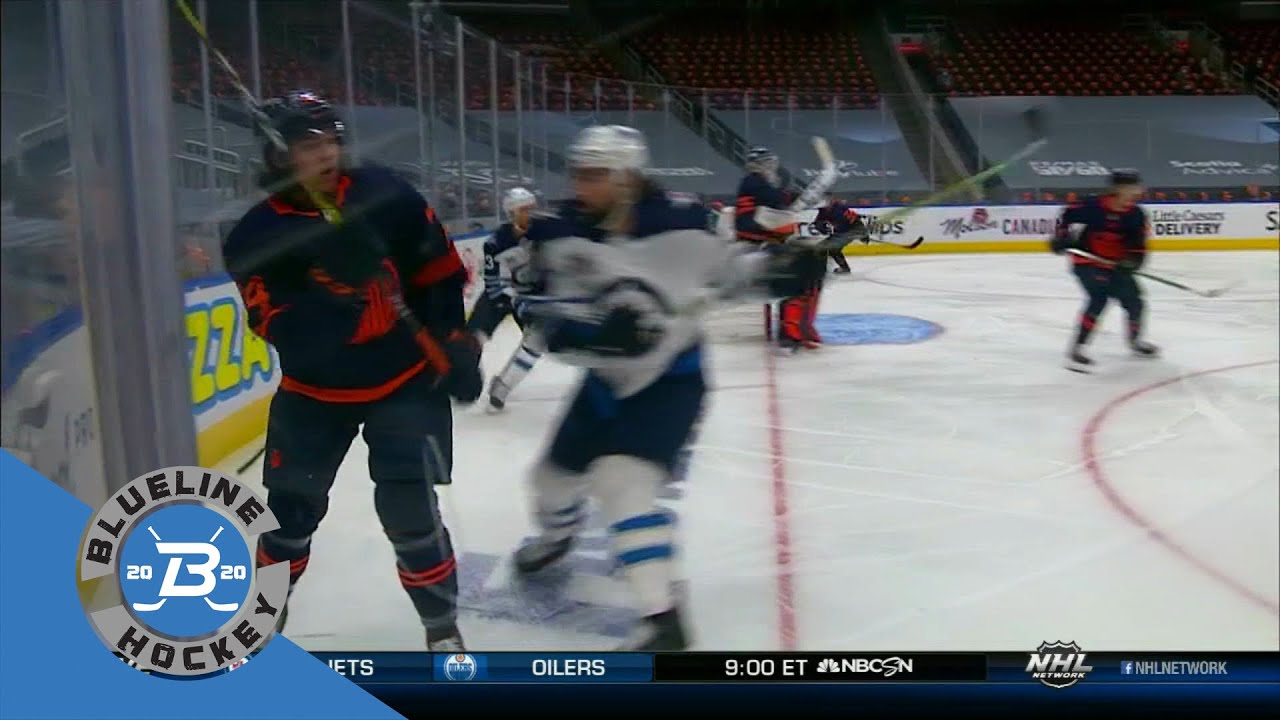 Adam Lowry with a hit on Leon Draisaitl and Logan Stanley drops Jujhar Khaira.