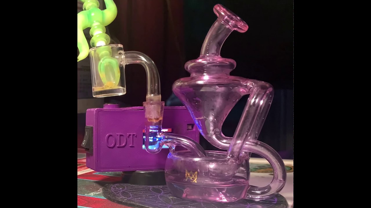 MJ Arsenal Claude Mini Rig with a bear Quartz banger smoking on cookies and cream