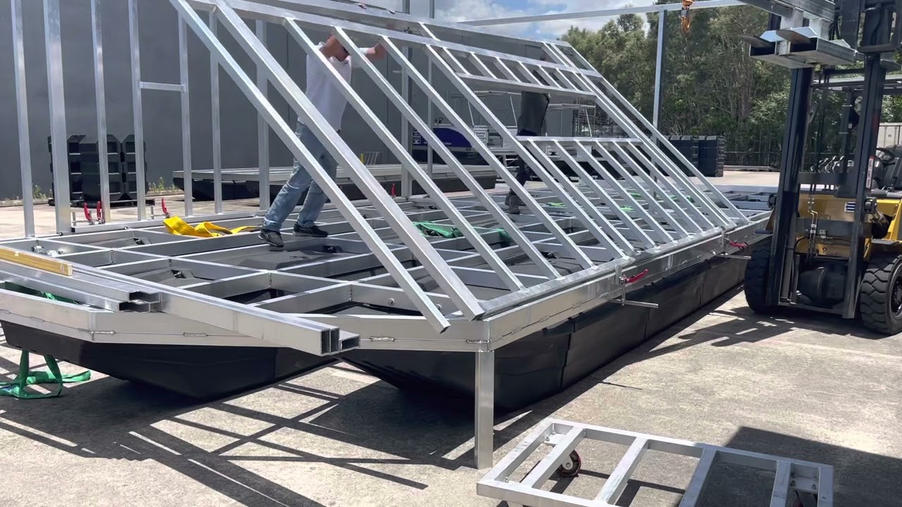 Houseboat build erecting walls and welding in position