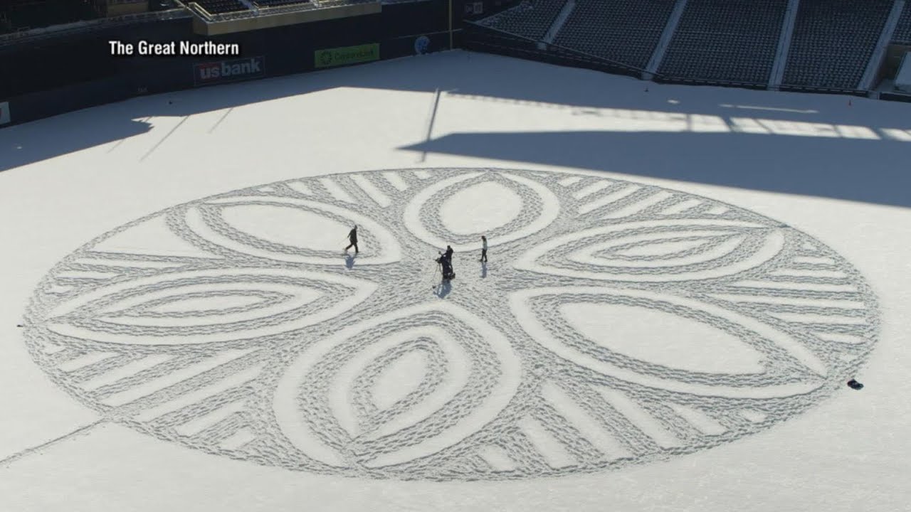 Artist uses his feet to create massive murals in the snow