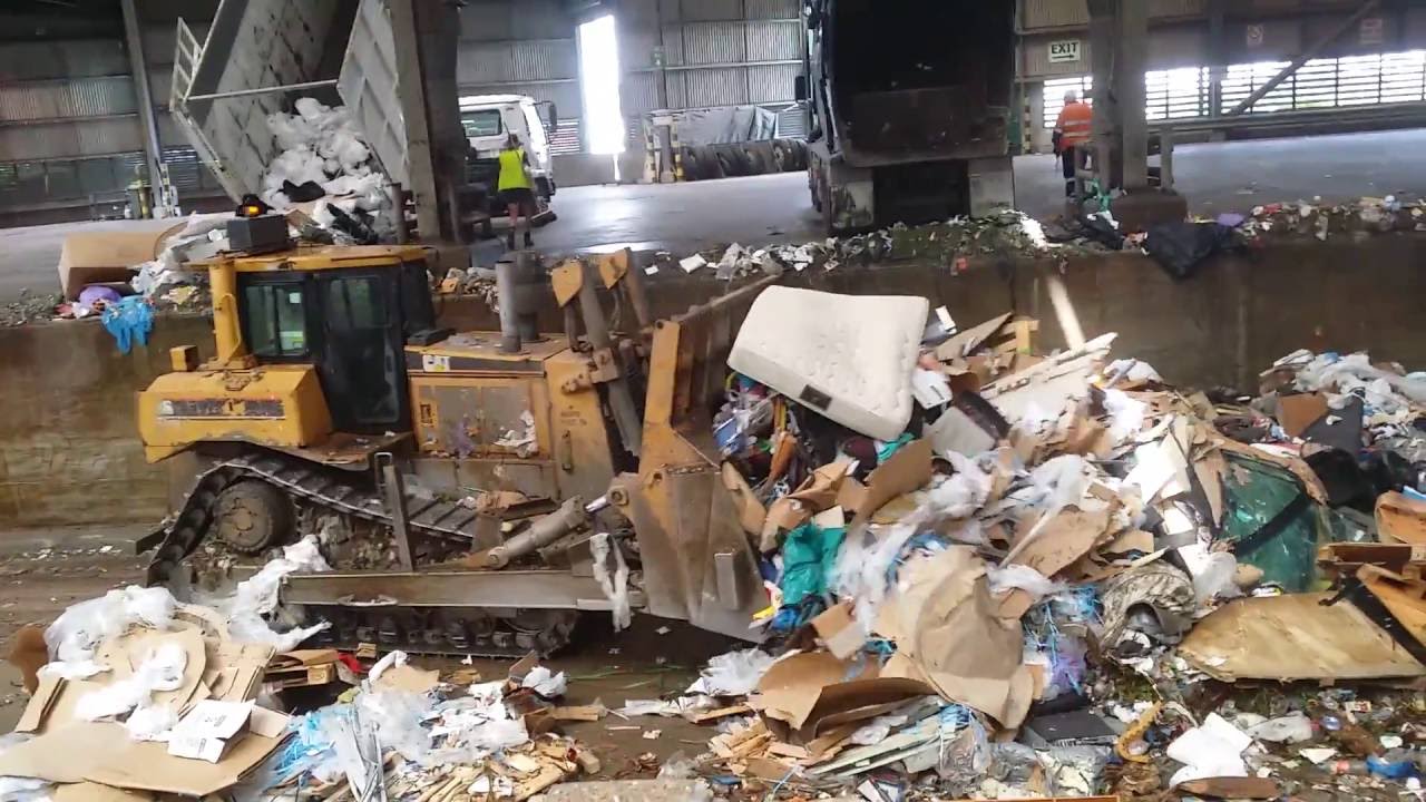 Bulldozer cleaning up at the tip