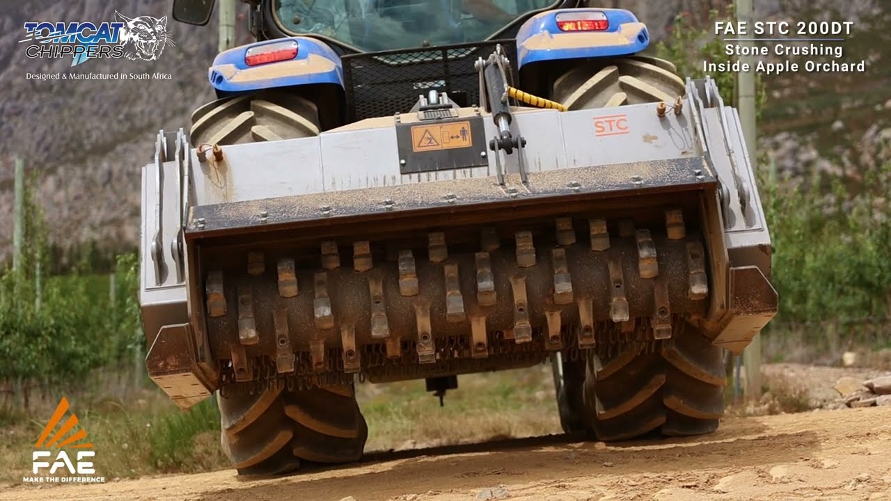 FAE STC200DT PTO stone crusher machine behind New Holland tractor crushing rocks in apple orchards