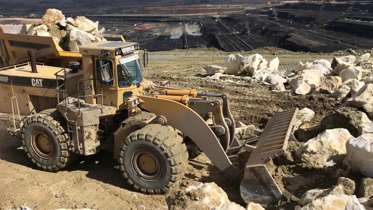 Caterpillar 988F Wheel Loader Loading Stones On Komatsu Dumpers - Kivos Ate