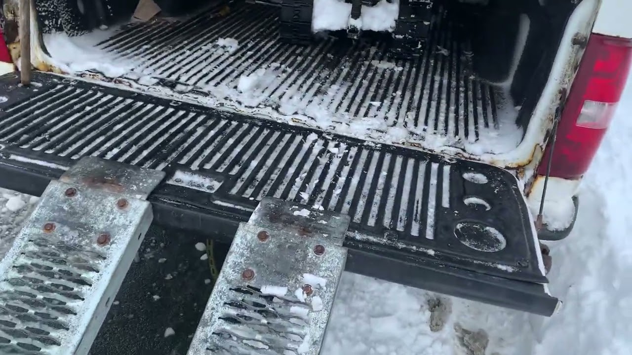 Loading a snowblower into a truck.