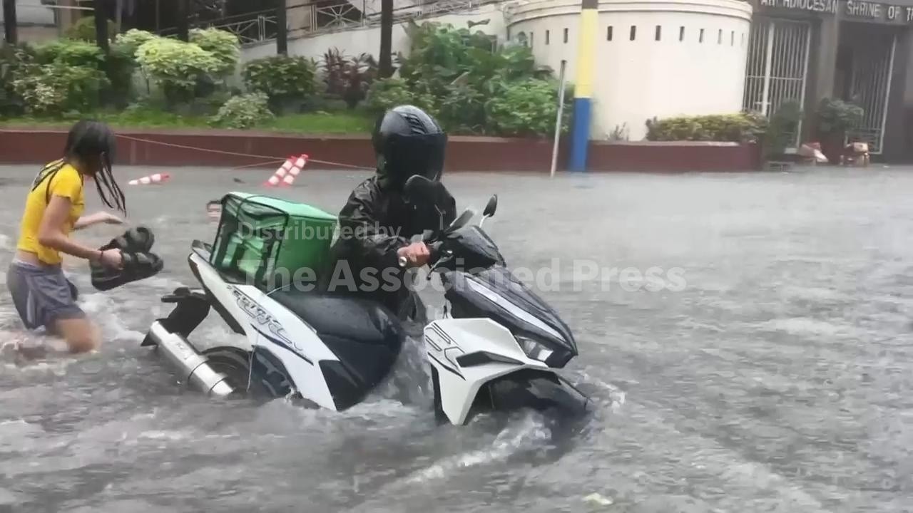 Heavy rains caused by southwest monsoon flood many streets in Manila