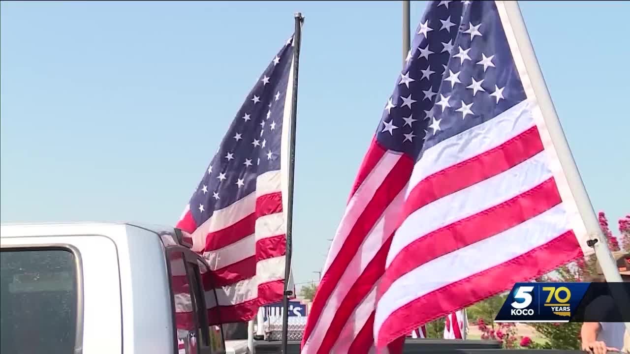 Cars and trucks with American flags circle Edmond school after student was told he couldn't fly his