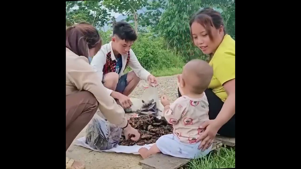 A Mother and Son Harvest Yellow Clams During Their Daily Work