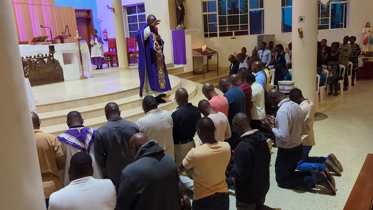THE PRIEST BLESSING MEMBERS OF MEN'S GUILD NTINDA B4 SETTING OFF TO KIBEHO RWANDA ON THE 18TH FEB 26