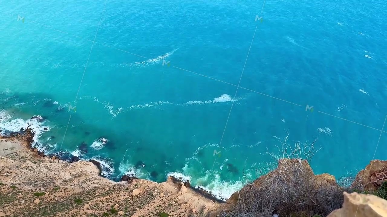 Experience a Stunningly Beautiful Coastal View That Overlooks the Vast Azure Sea