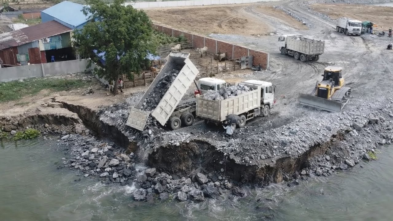 25T Dump Trucks Loading Stones Filling Big Lake With Bulldozer