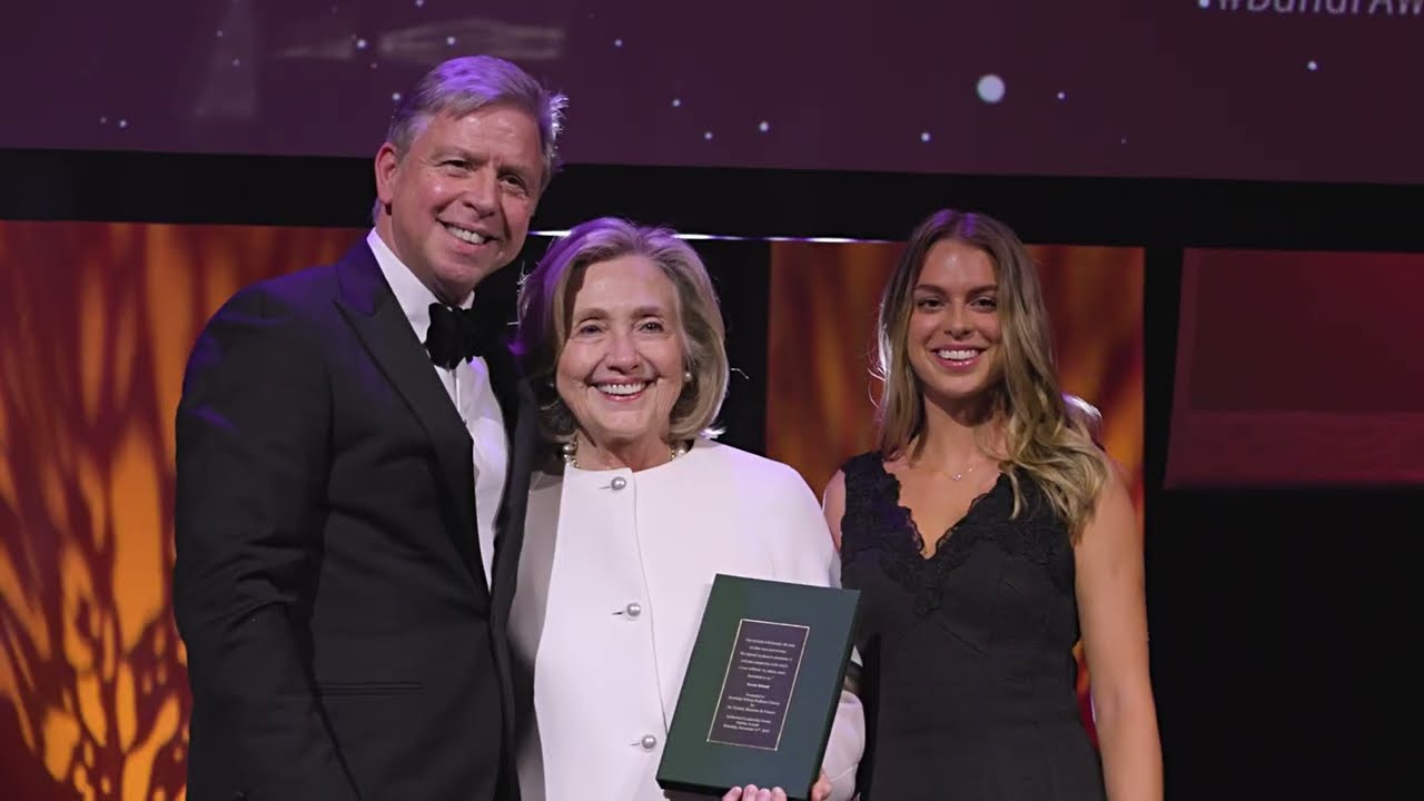 Ian Hyland presents the Sutherland Leadership Award to  Secretary Hillary Rodham Clinton