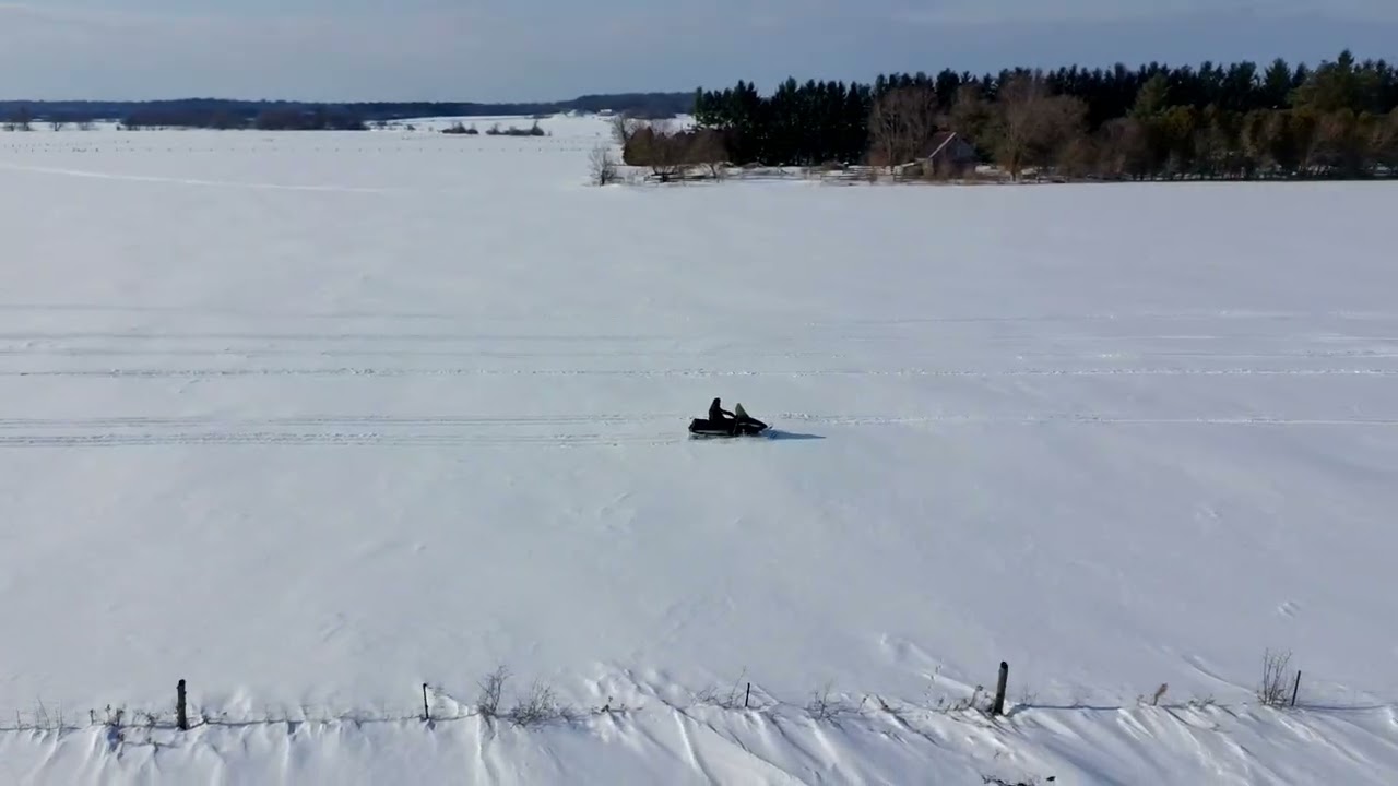 Snowmobile side shot from Potensic ATom 2 drone