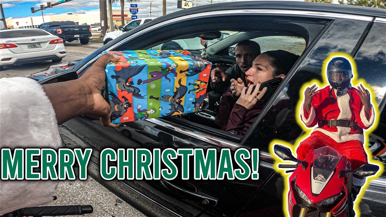 Santa Claus Giving Away Gifts On A Motorcycle