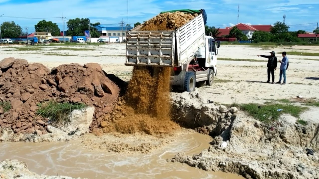 GREAT Job ! Dump truck unloading soil landfilling up with smart operator bulldozer pushing soil fill