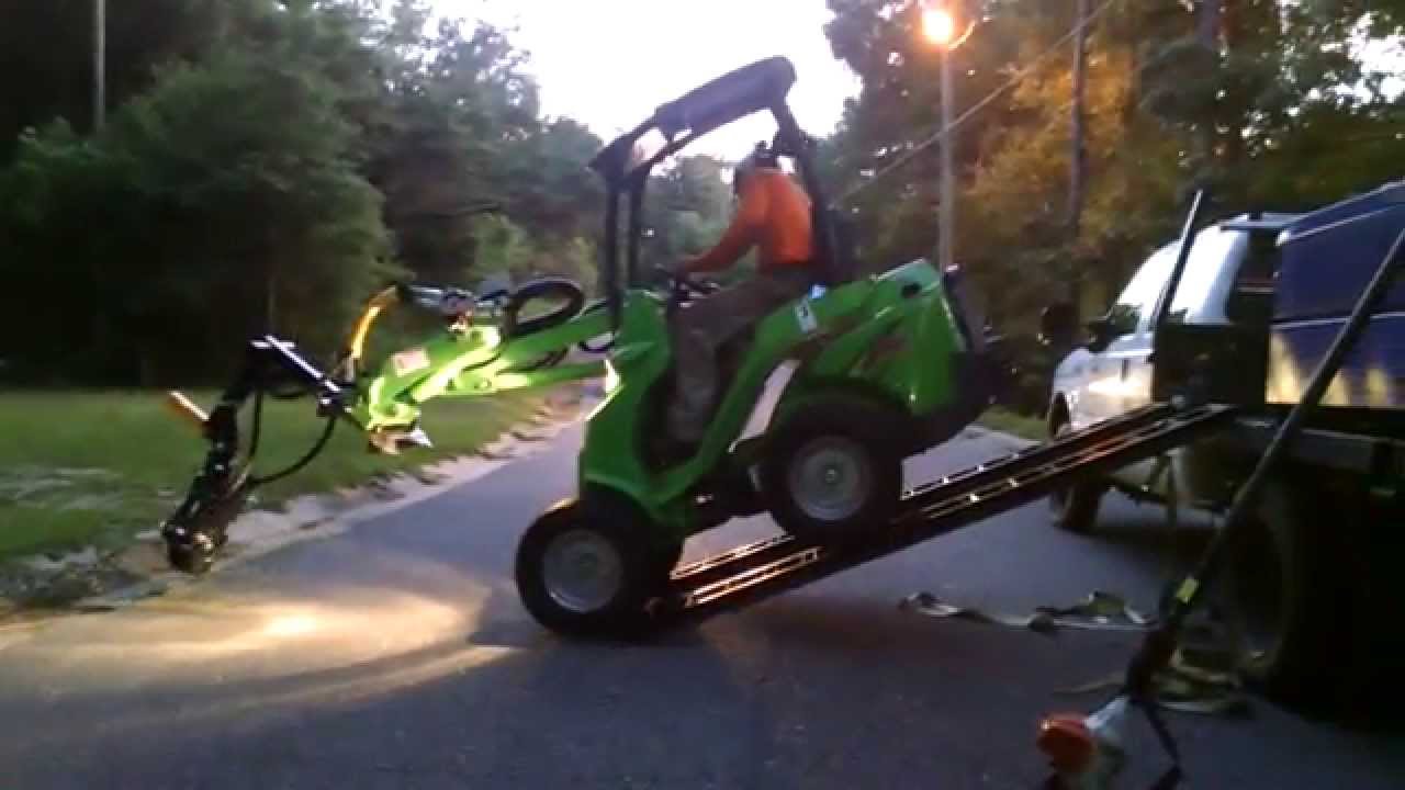 Avant 420 and Branch Manager Grapple dragging brush up a hill
