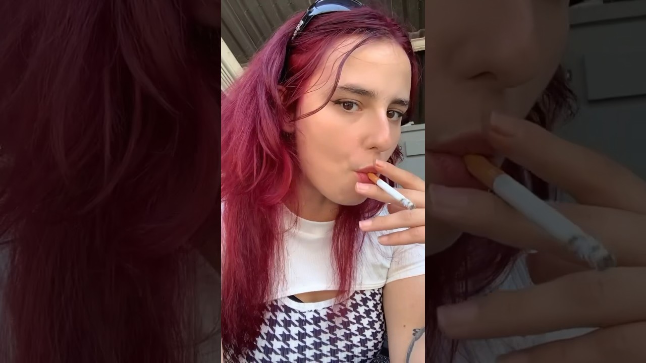 Beautiful redhead young heavy smoking a cigarette