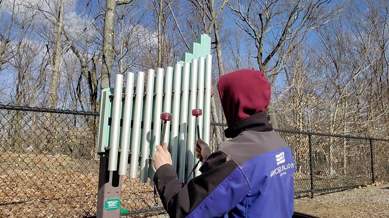 playing pipe chimes at a playground.
