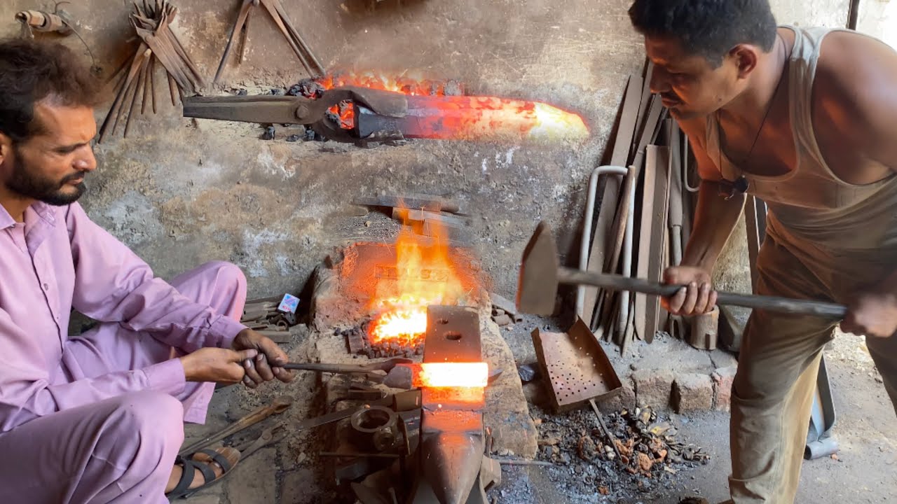 An Iron cutting chisel is being prepared at the furnace.