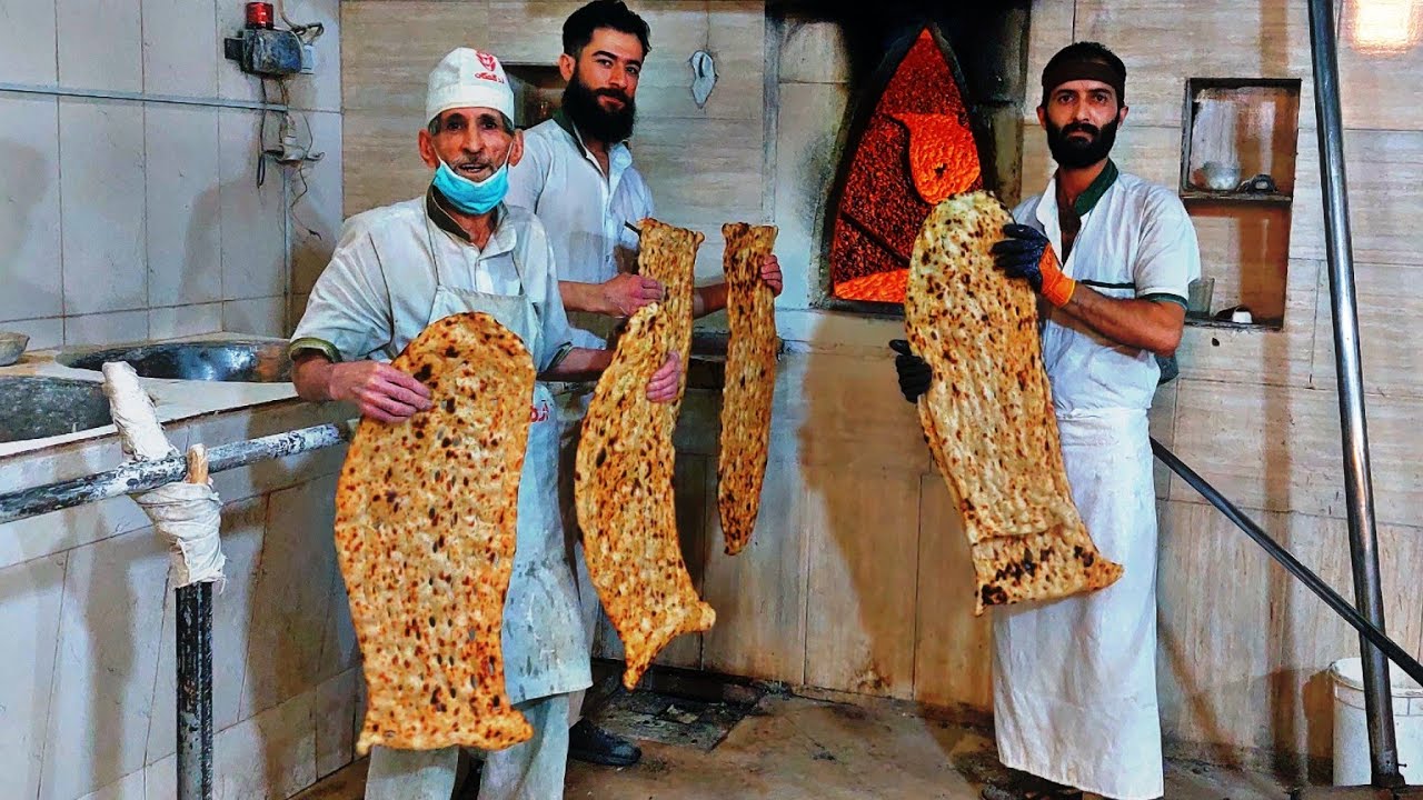 Original Sangak bread is baked on a hot stone in a bakery, Original Sangak bread