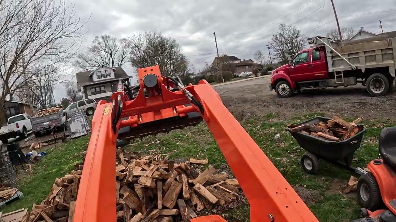 Moving cherry with the mini skid, grapple, lawn tractor and trailer