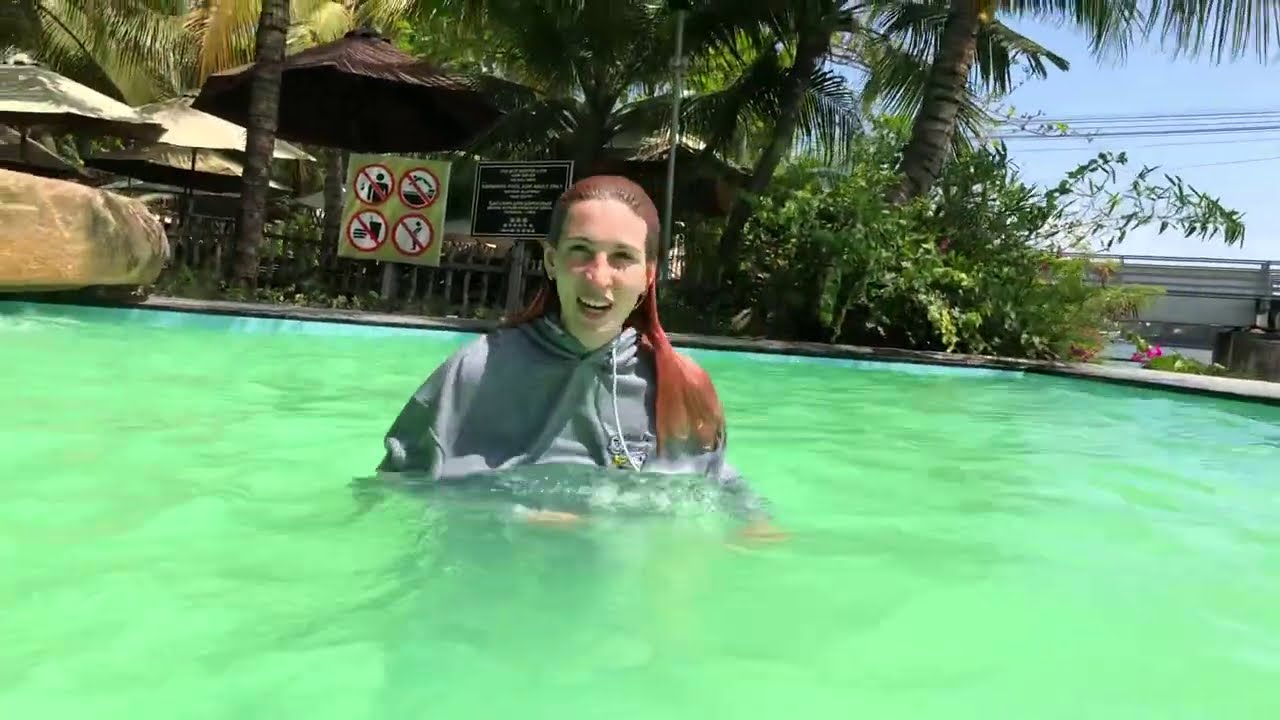 Beautiful pool with green water in a gray sports suit Kris