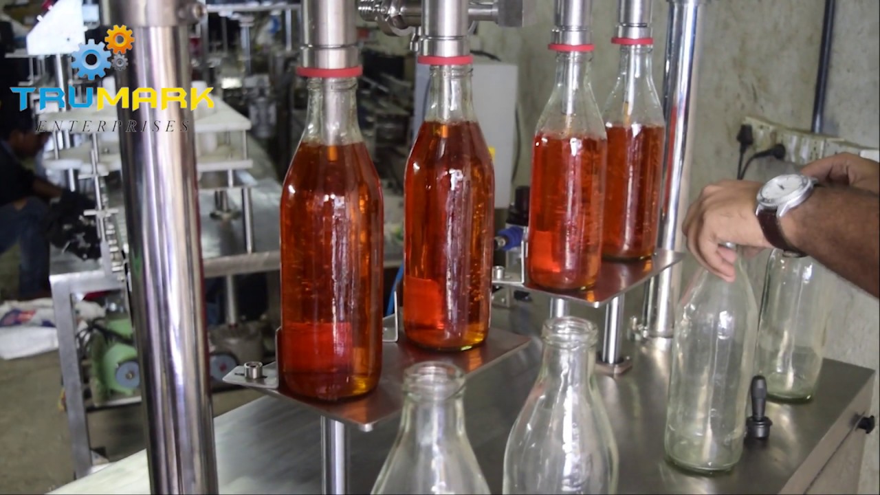 Semi automatic gravity based liquid filler, liquid filling machine