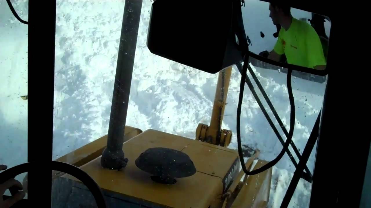 Plowing snow in a Deere 310E Backhoe