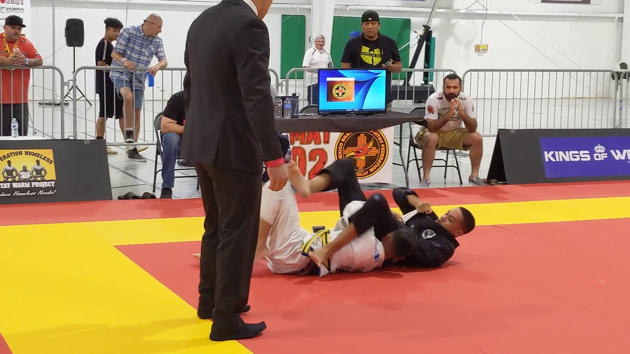 Gabe winning his first BJJ Tournament by submission (triangle)