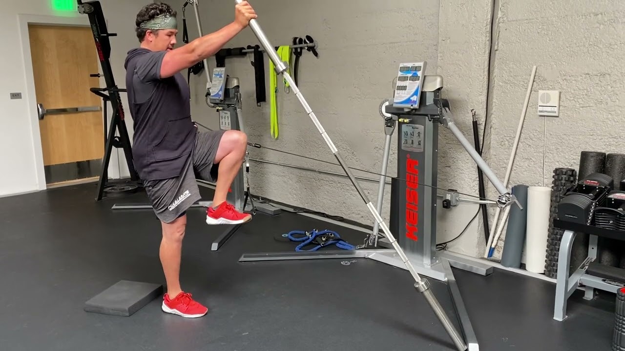 Half kneeling cable row with thoracic rotation landline overhead press and single leg stabilization