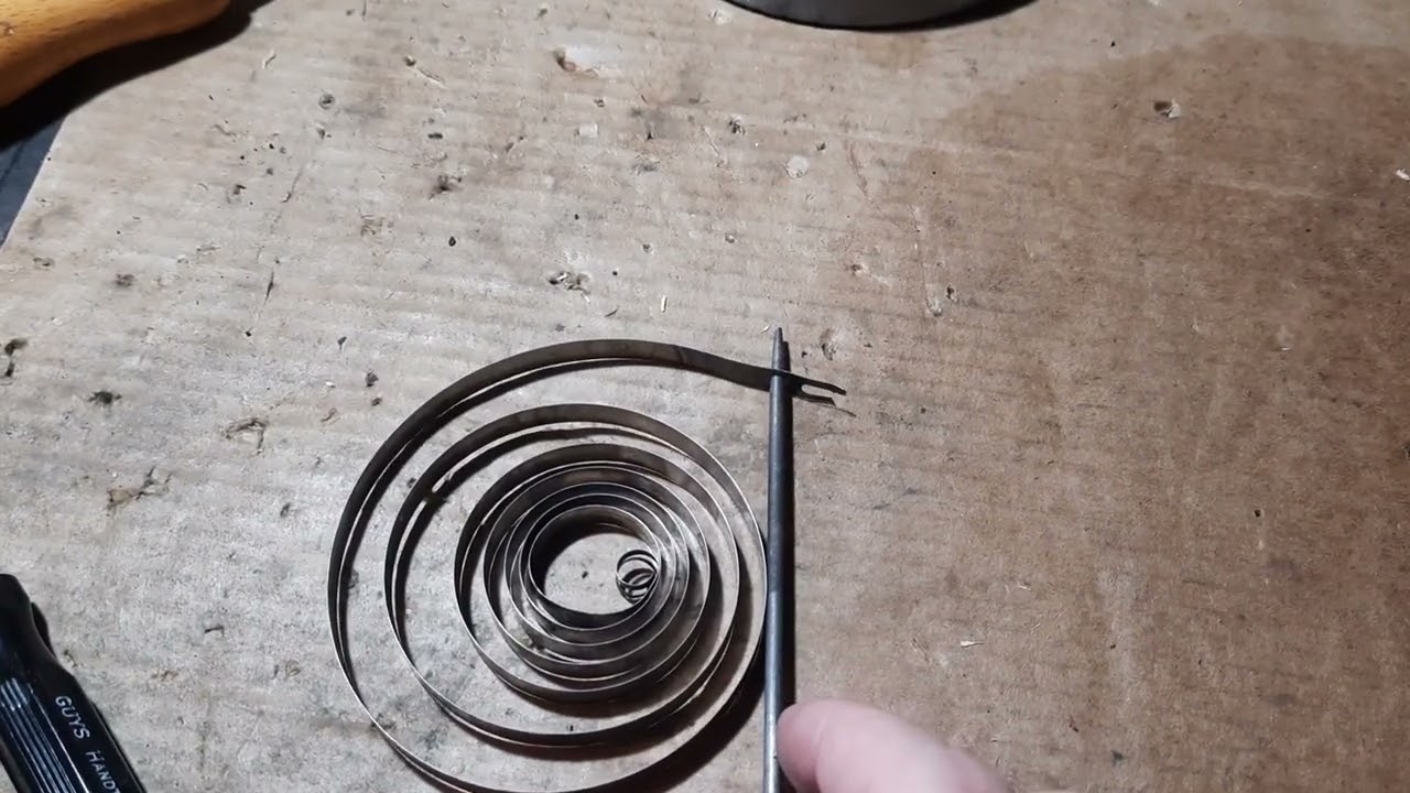 Making a new hole in an alarm clock barrel mainspring