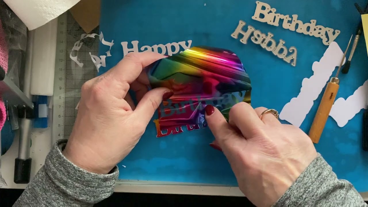 Foiling with adhesive sheets