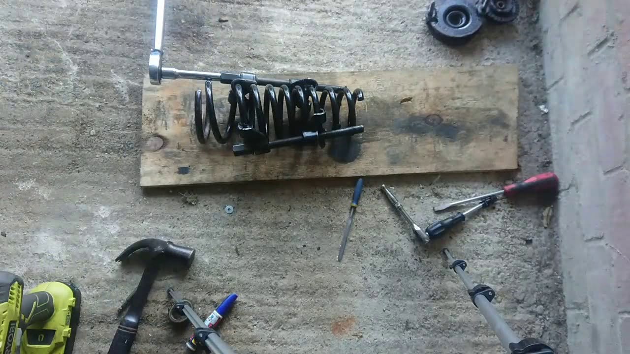 Compressing the front suspension Coil on an Alfa Romeo GT, then rebuilding shock absorber.