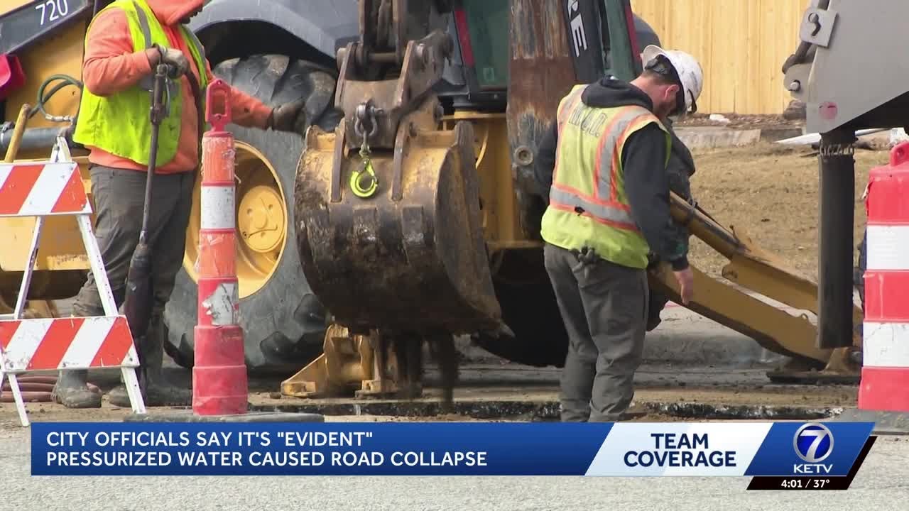 Omaha officials investigate cause of water main break, sinkhole that trapped two vehicles