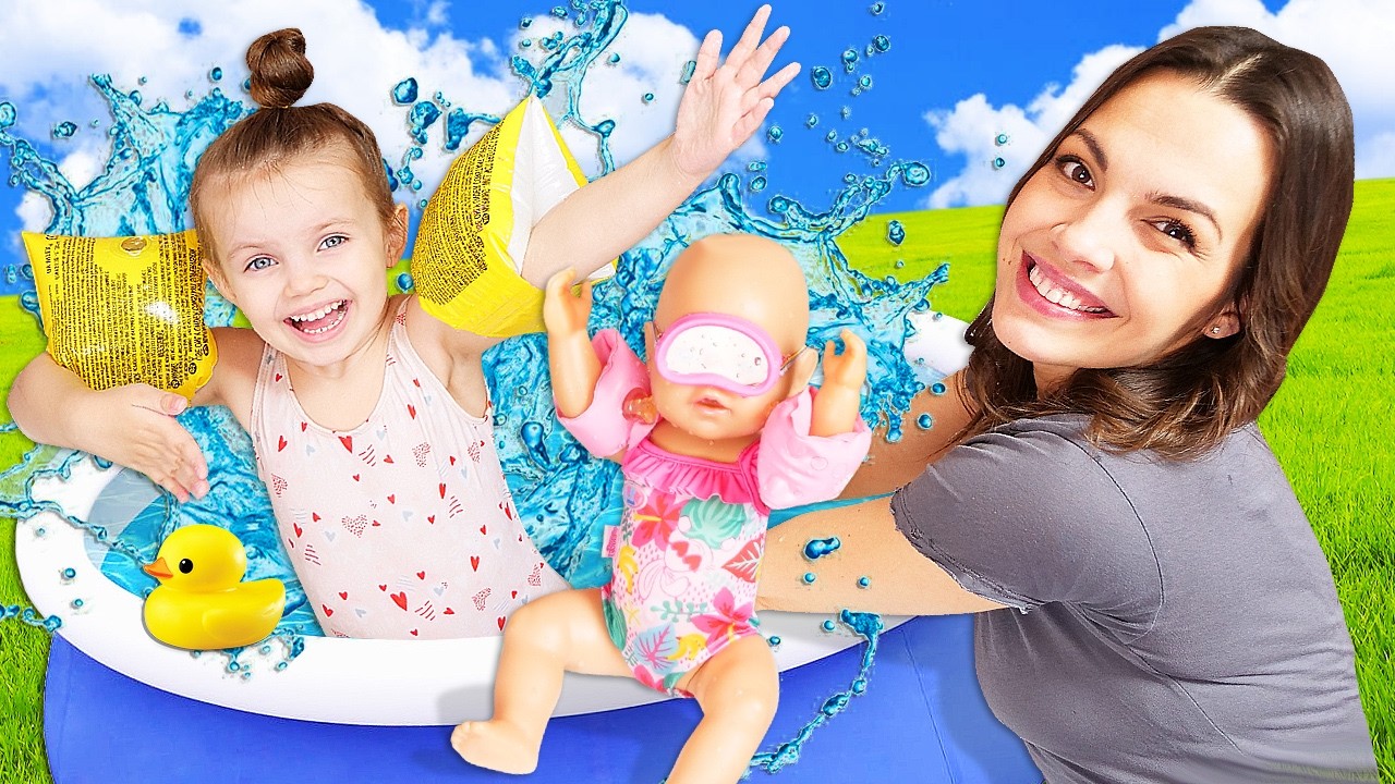 Maya bathes her baby doll in a bathtub with colorful balls.