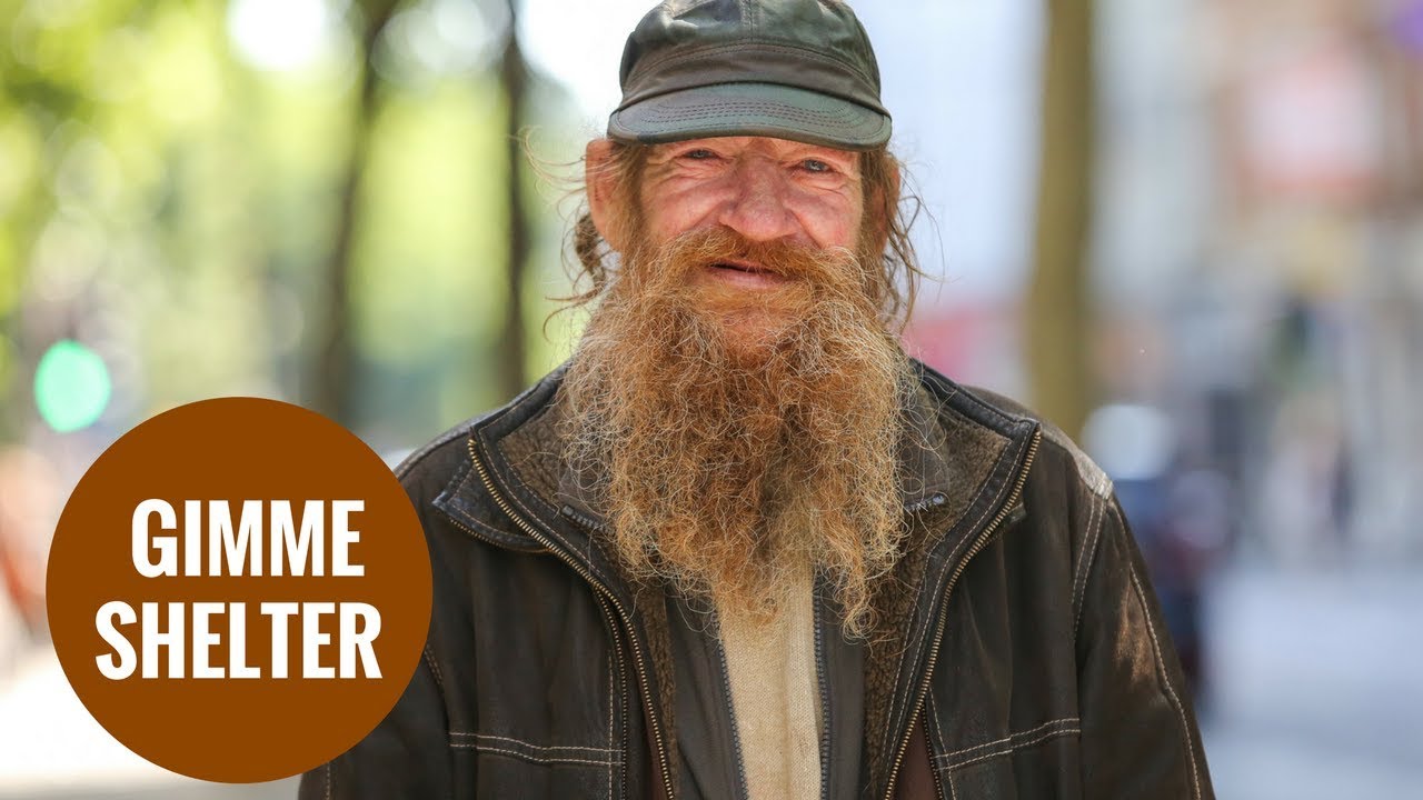 A homeless man sleeps rough opposite Shelter charity