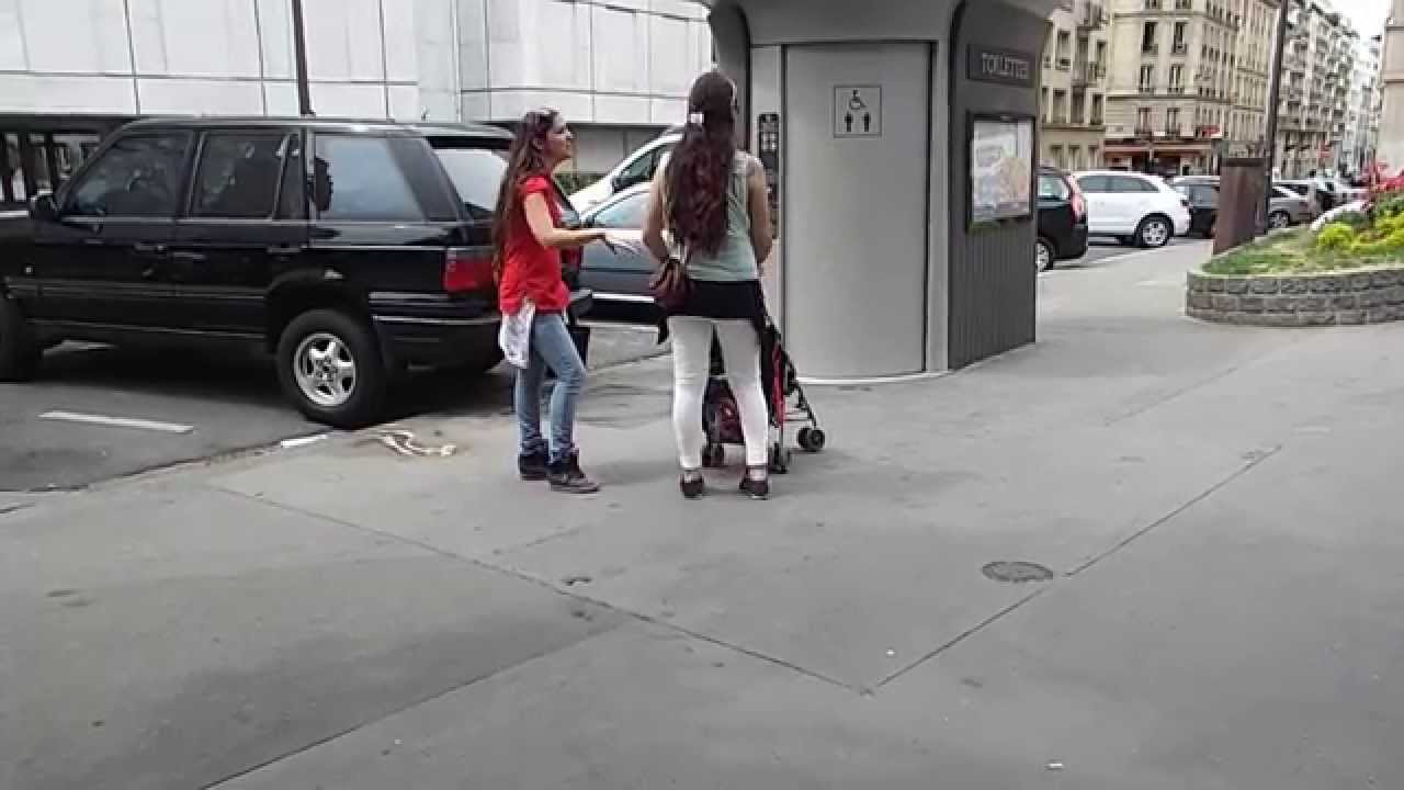 Ladies fidgeting for the public toilet