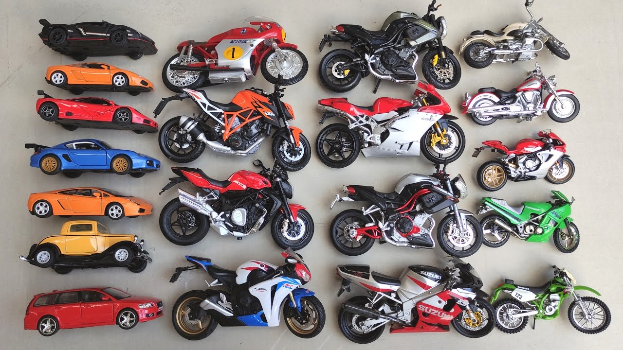 Various Diecast Metal Scale Model Cars and Motorcycles Being Reviewed In Hand