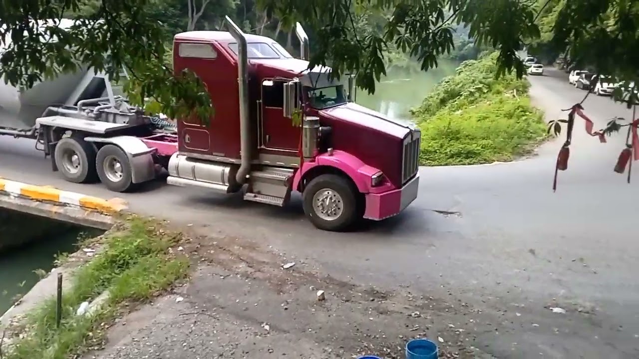 Trucks going across flat bridge 