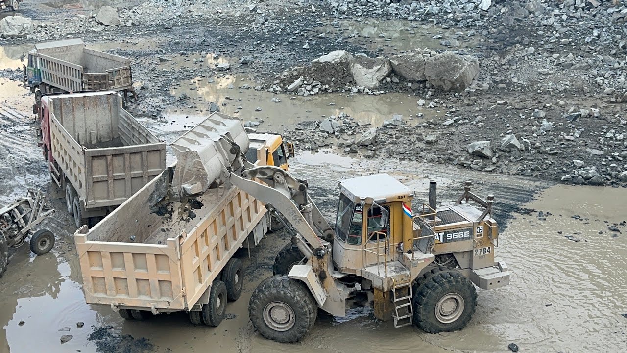 with RocksPowerful CAT 966D Loader Loading Stoneinto DumpersHeavy Equipment CAT 966D Loader Loading
