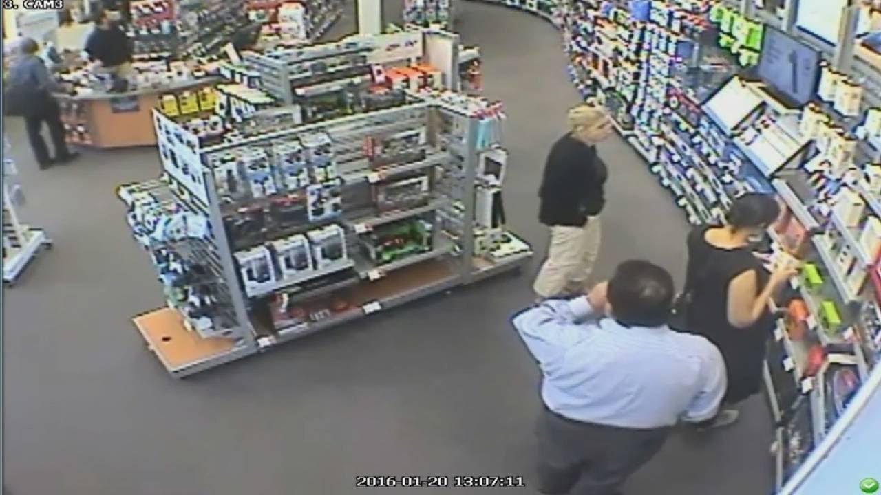 Woman caught on camera stuffing electronics under dress