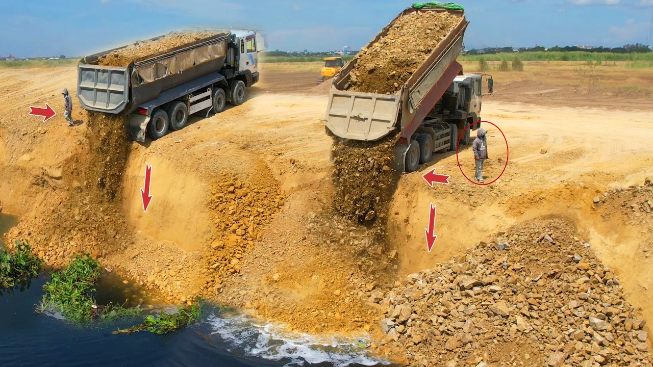 Incredible!, 25 ton dump truck fills large lakes and flooded land with KOMATSU Dozer, pushes rocks