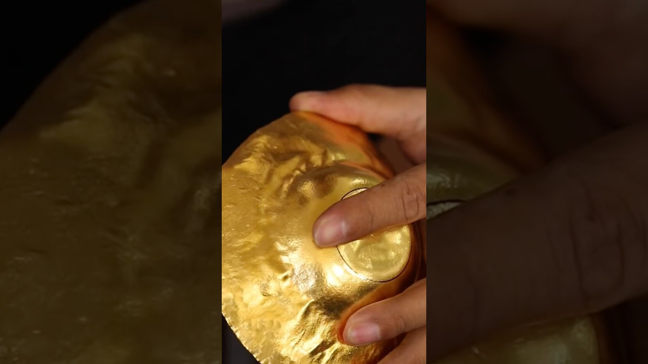 The process of handcrafted production of a gold tea pot and cup made from Au999 gold. 