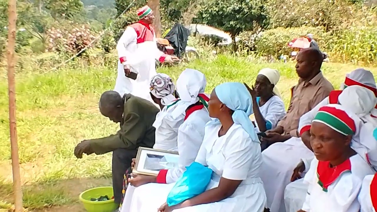 Pastor. Ebrahim preaching during burial ceremony.