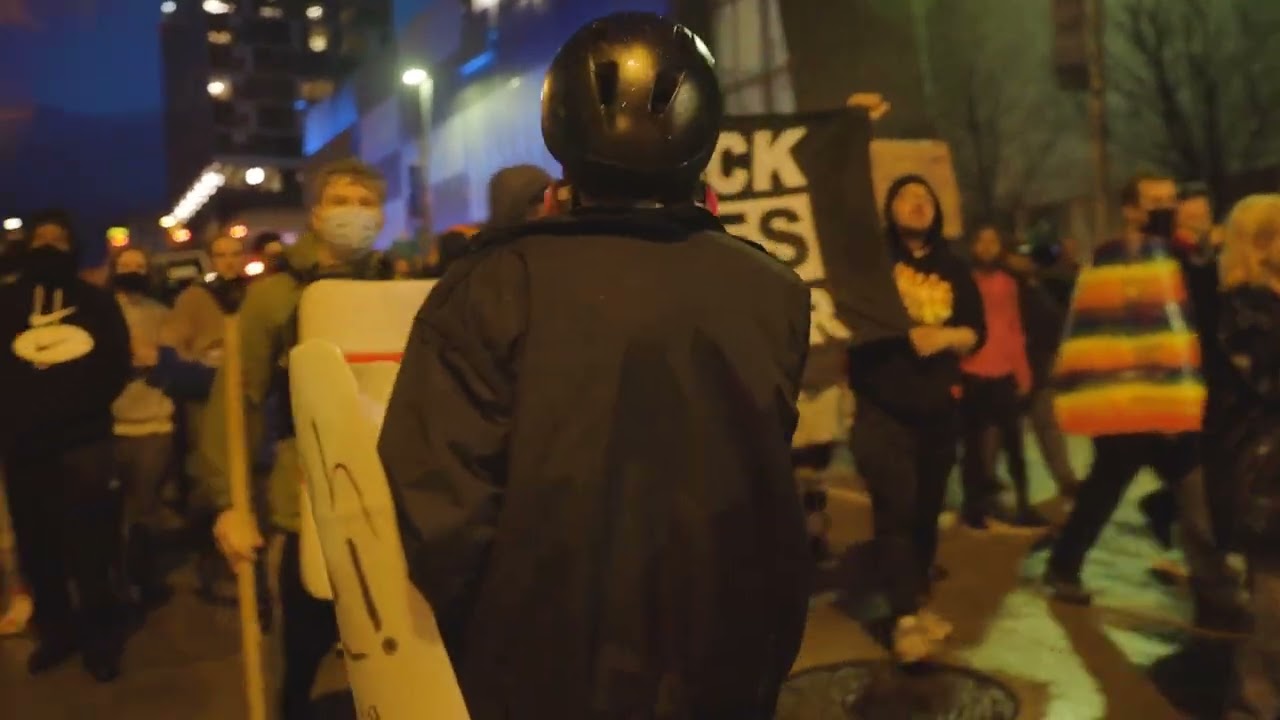 Protesters march around the Grand Rapids Police Department