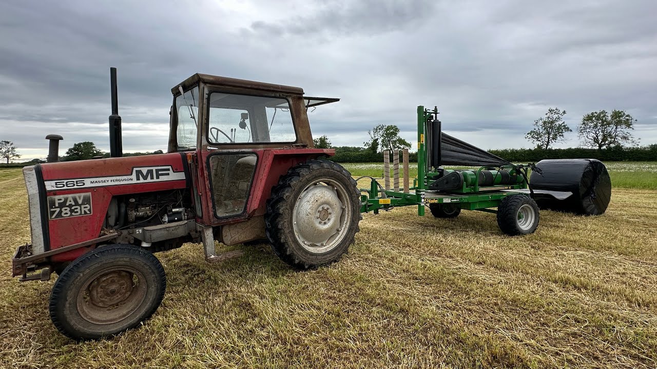 Massey 565 with a mc hale bale wrapper (full throttle)