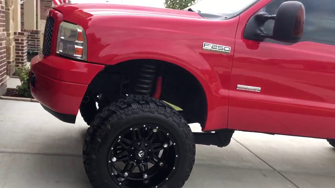 lifted Ford F-250 6.0 walk around with painted front bumper and mesh grille