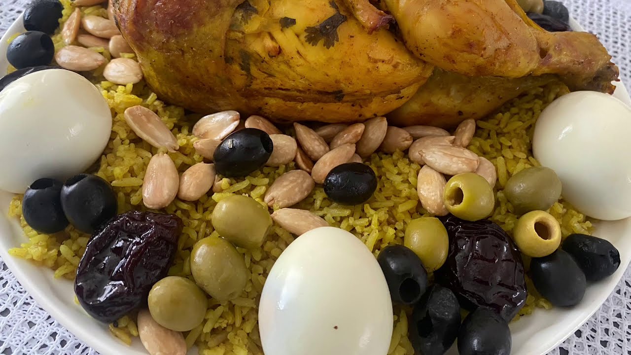 chicken with rice  =الـــدجاجــــة مــع الــروز في الفران و تزيينه بالبرقوق و اللوز و اليتون