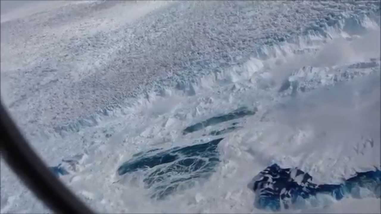 largest aerial view of World's fastest glacier, calving enormous iceberg