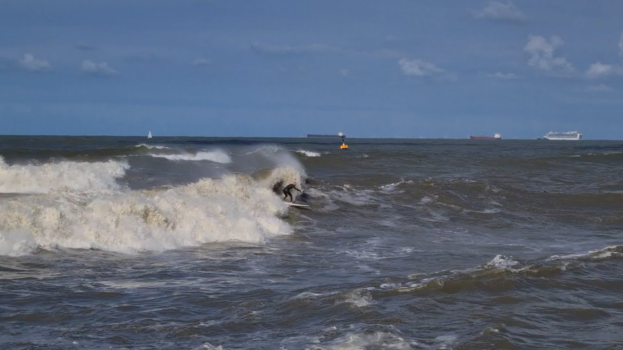 Sufers in big waves at Scheveningen on 26 september 2020